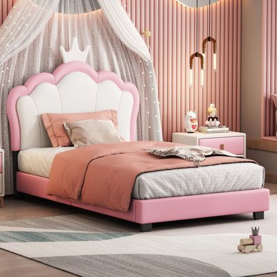 a bedroom with pink and white furniture in the corner, including a bed frame that has a canopy over it