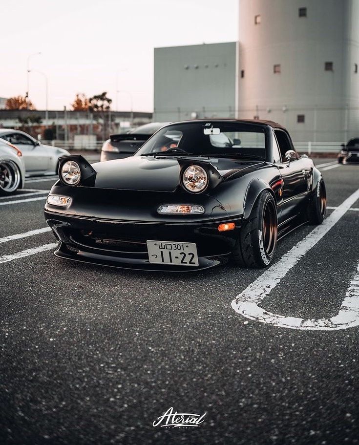 a black sports car parked in a parking lot