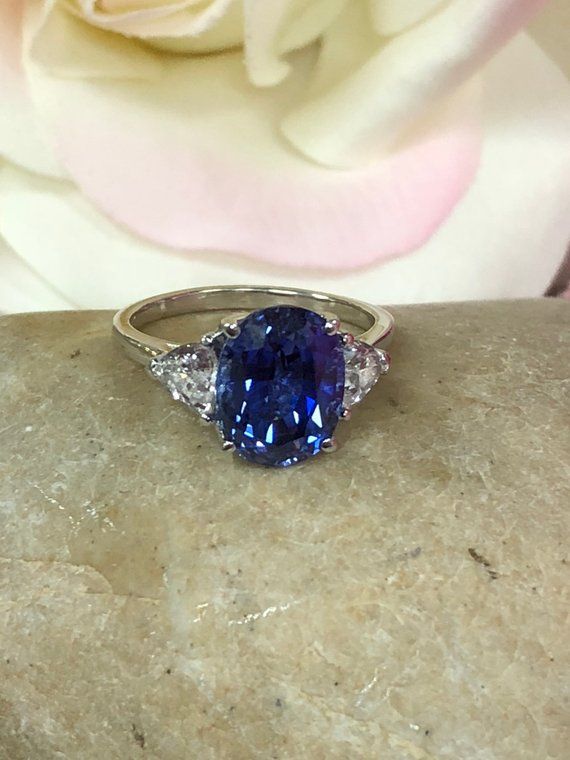 Oval ceylon blue sapphire and trillion accents 14k white gold | Etsy Blue Sapphire Gemstone With Center Stone, Blue Tanzanite Ring With Trillion Cut, Trillion Cut Sapphire Gemstone Ring For Anniversary, Classic Trillion Cut Sapphire Ring, Sapphire Trillion Cut Ring, Fine Jewelry Trillion Cut Sapphire Ring With Accent Stones, Trillion Cut Blue Sapphire Ring For Gift, Trillion Cut Sapphire Promise Ring, Trillion Cut Sapphire Gemstone Ring