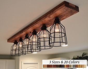 the light fixture is made from wood and has five lights on each side, with wire cage