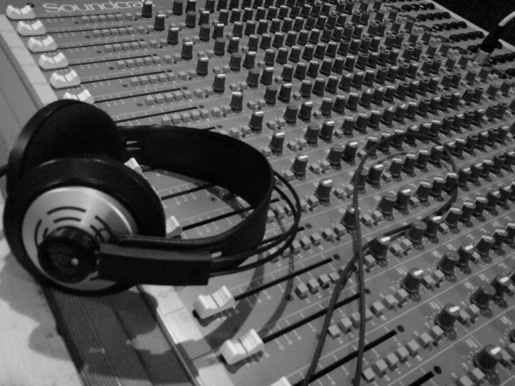 an audio mixing console with headphones on it's side and the caption muzyka