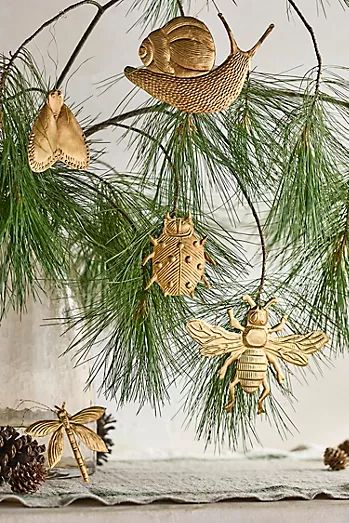 some ornaments are hanging from a pine tree