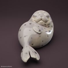 a ceramic sea lion laying on its side