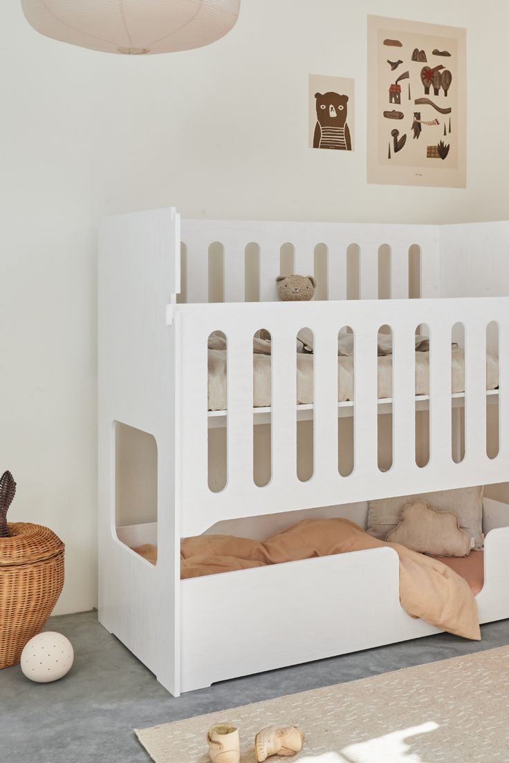 a white bunk bed sitting in a bedroom next to a potted plant on the floor