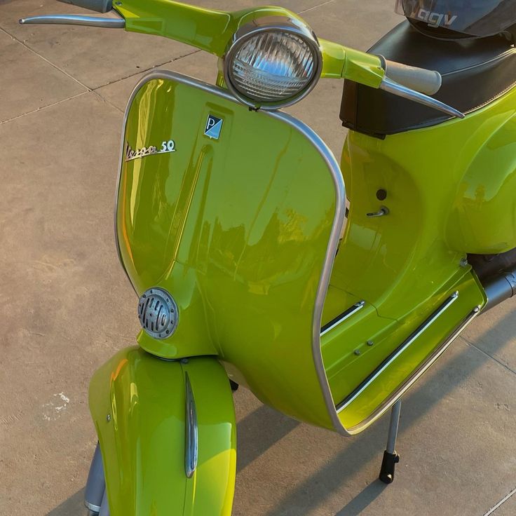 a lime green scooter is parked on the sidewalk