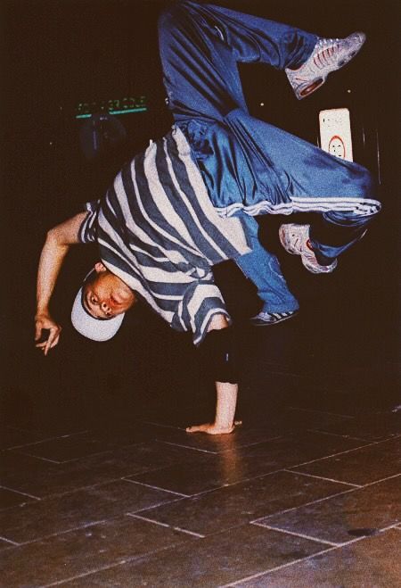 a man doing a handstand on the floor with his feet in the air