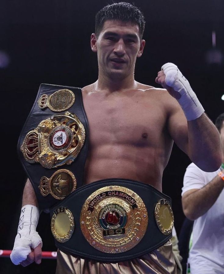 a man standing in the middle of a boxing ring