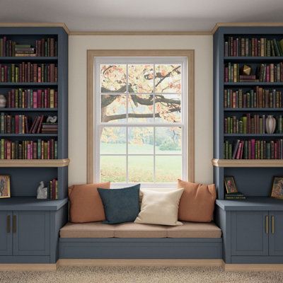 a room with bookshelves, couch and window