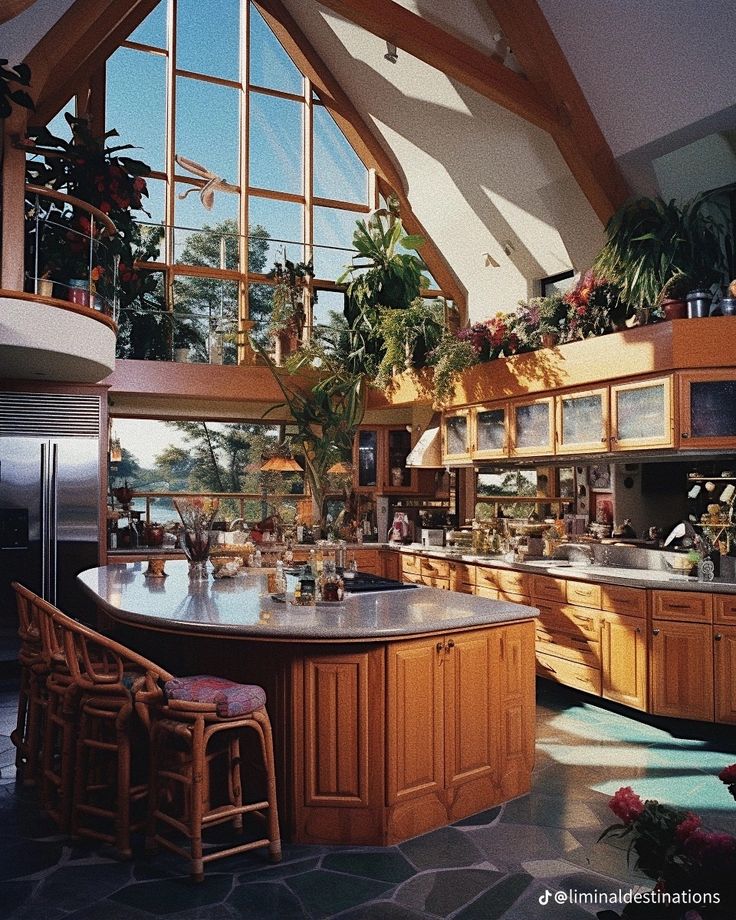 a large kitchen with an island in the middle and lots of plants growing on it