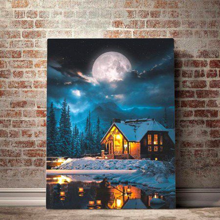 a painting on a brick wall in front of a night scene with a house and full moon