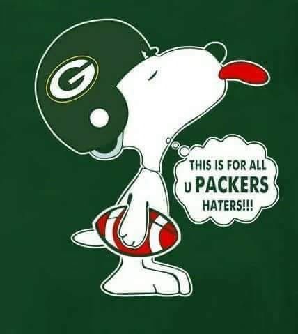 a green bay packers shirt with a cartoon dog holding a football in it's mouth