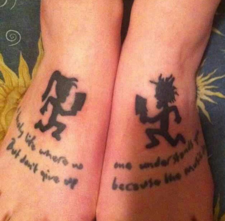 two people with matching tattoos on their feet, one has a book and the other is reading