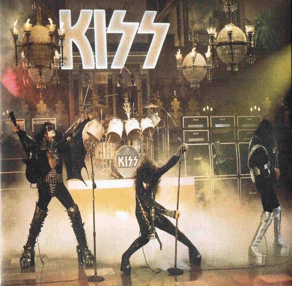 the kiss band performing on stage with their arms in the air