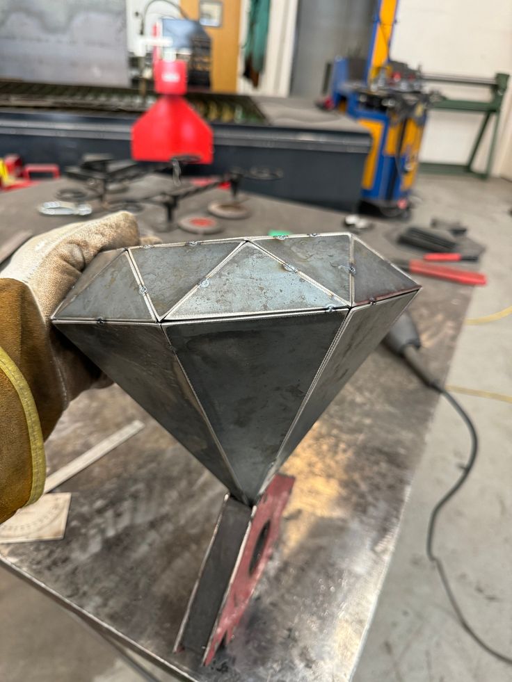 a metal object being worked on in a factory