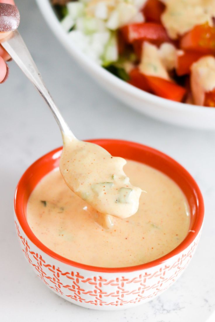 a spoon full of soup with the words copycat big mac sauce perfect for burgers, fries and salads