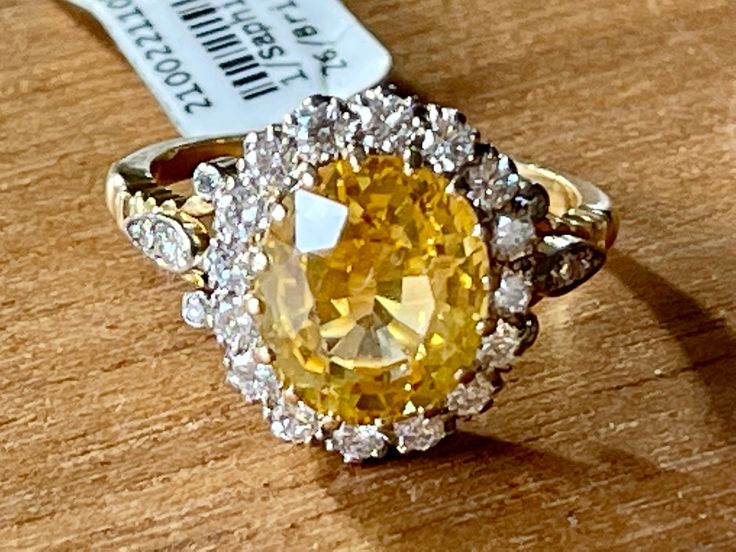 A bright yellow Sapphire is the central point of this classic Vintage Entourage Ring in 18 K yellow Gold. The yellow Sapphire has a weight of approximately 4.80 ct and is surrouded by 26 brilliant cut Diamonds weighing approximately 0.70 ct. The ring is currently size 55/15( US size 7 1/2) but can easily be resized. Masterfully handcrafted piece! Authenticity and money back is guaranteed. For any enquires, please contact the seller through the message center. Luxury Heirloom Yellow Sapphire Jewelry, Canary Diamond Engagement Ring, Yellow Diamond Earring, Canary Diamond, Message Center, Yellow Sapphire Rings, Fancy Yellow Diamond, Yellow Sapphire, Yellow Diamond