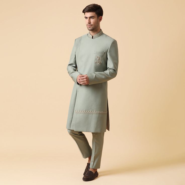 A Classic indo set in pista green shade with hand-worked motif on chest and embroidery on the lower side of the jacket with same pants. Subtle draping and work make it the absolute choice for an engagement or a sangeet outfit for a groom or wedding guests. Delivery Period- 20 Days Festive Pista Green Bandhgala With Traditional Drape, Traditional Pista Green Sherwani With Drape, Traditional Drape Pista Green Sherwani With Pallu, Semi-stitched Pista Green Sherwani With Resham Embroidery, Embroidered Semi-stitched Pista Green Sherwani, Pista Green, Sangeet Outfit, Traditional Clothes, Indo Western