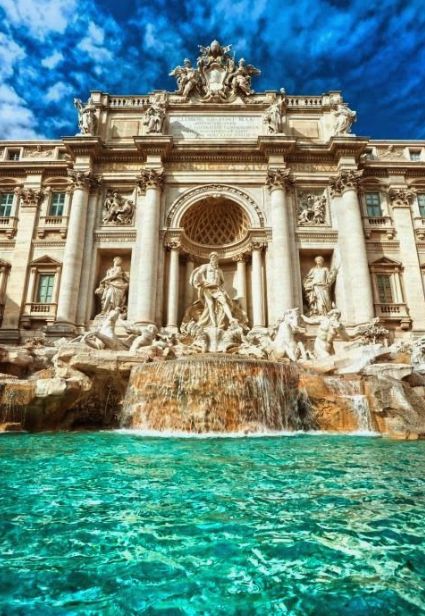 the trello palace in rome, italy with blue skies and clouds above it's water