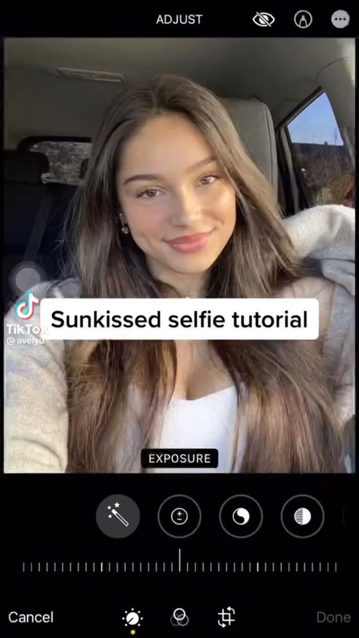 a woman with long hair is on her cell phone and she has the text sun kissed selfie