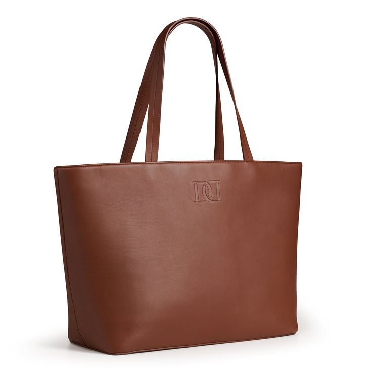 Sleek, Sophisticated and PracticalThe perfect tote - It is both sleek and functional. The dimensions of this tote allow you to comfortably carry anything from your laptop to your make up case and all your essential items in between.● Item SKU: DESMY-BR22● Item Color: Brown● Height: 11.5in Width: 19in Depth: 6in● Handle drop: 9.3in ● Inside Zipper Compartment● Double top handles● Zipper closure● Gold metal fox head zipper pull● Metal feet at base of bag● Made in Spain● Composition: 100% Calf leat Chic Tote Laptop Bag For On-the-go, Chic Rectangular Laptop Bag For On-the-go, Luxury Large Capacity Laptop Bag For Shopping, Chic Brown Laptop Bag, Sleek Tote Bag For Daily Use, Elegant Large Capacity Laptop Bag For Everyday, Sleek Large Capacity Shoulder Bag For Travel, Elegant Top Handle Laptop Bag, Chic On-the-go Tote Laptop Bag