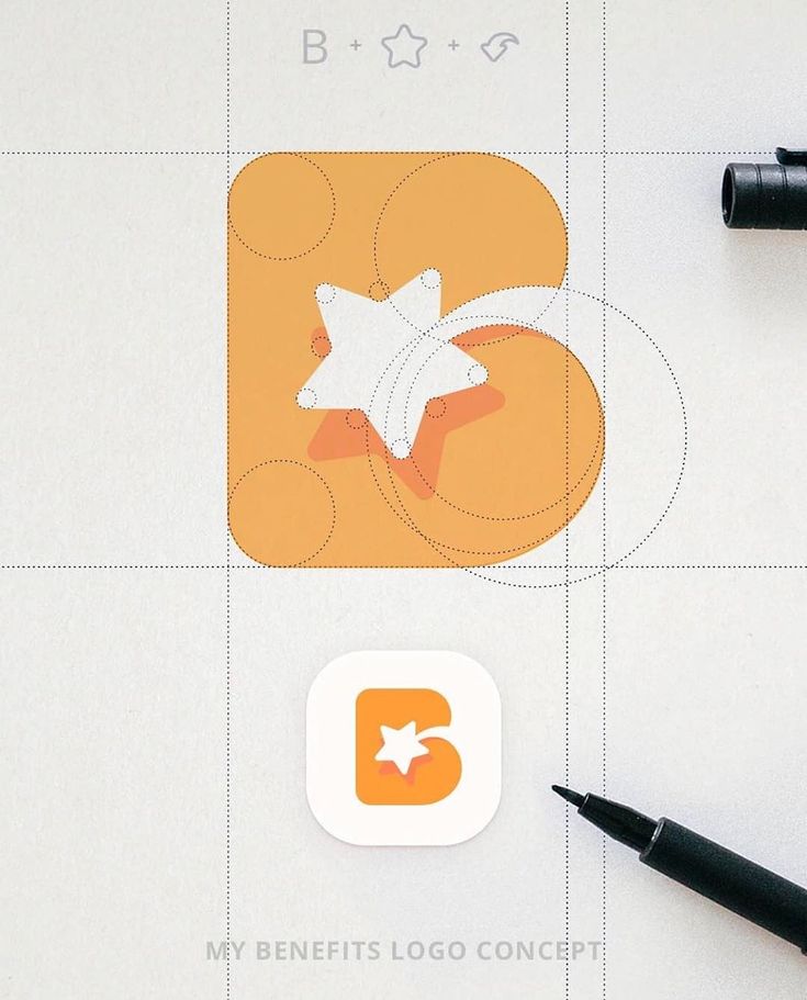 an orange and white square with a star on it next to some black marker pens