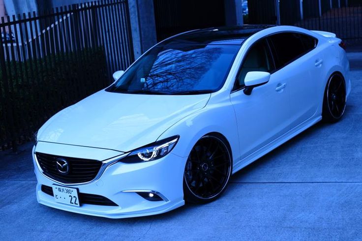 a white car parked in front of a building