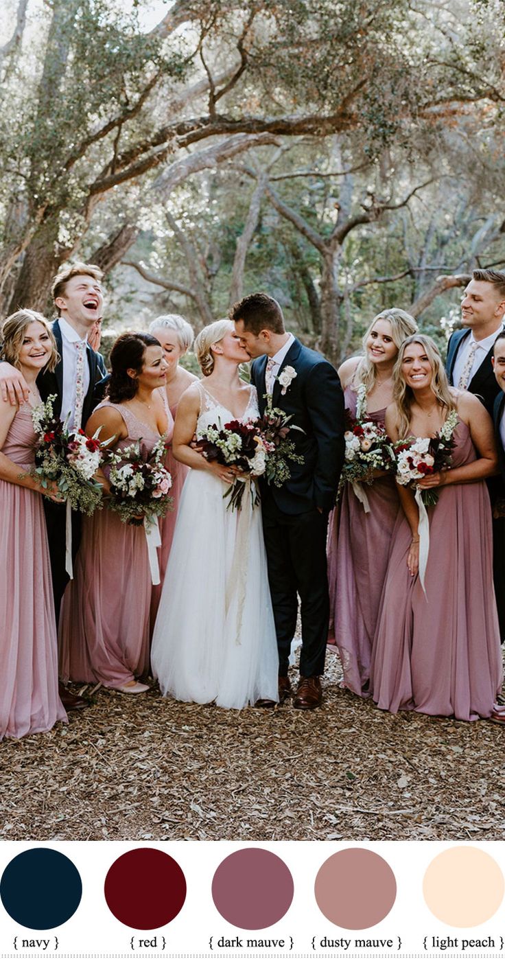 a group of people standing next to each other in front of trees with different colors