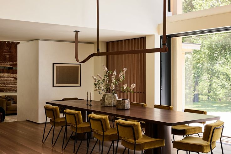 a dining room table with yellow chairs around it