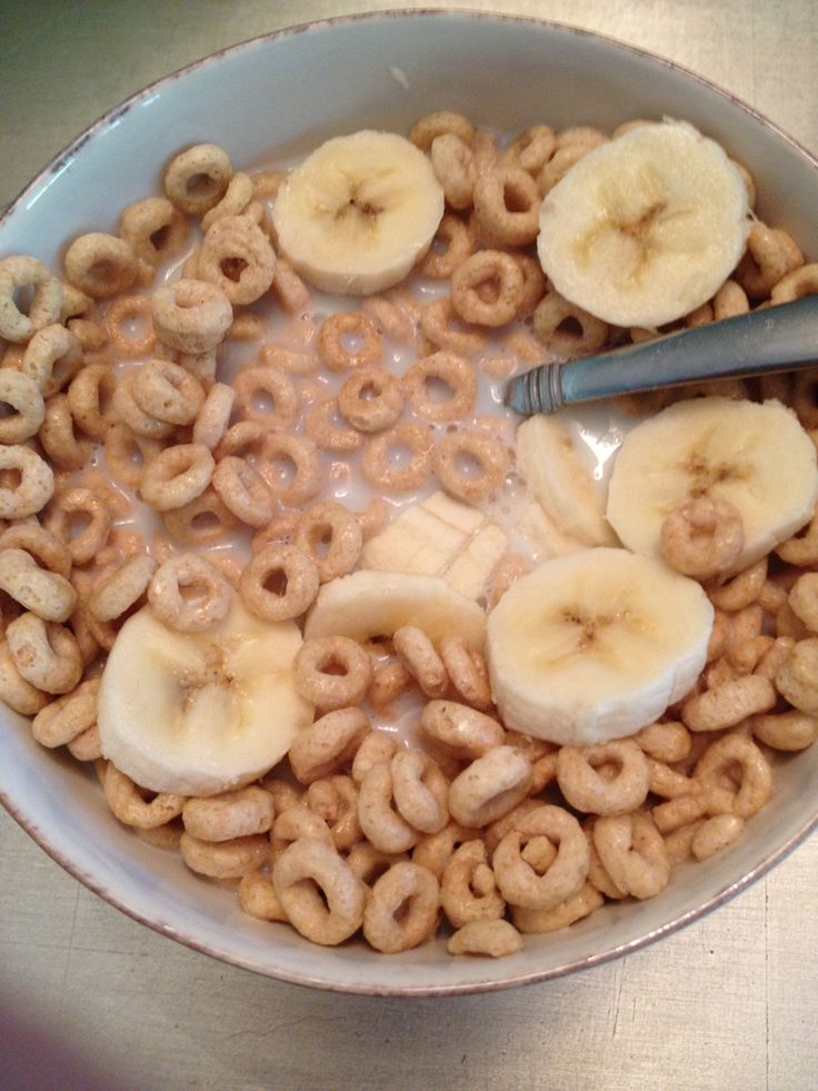 a bowl filled with cereal and sliced bananas