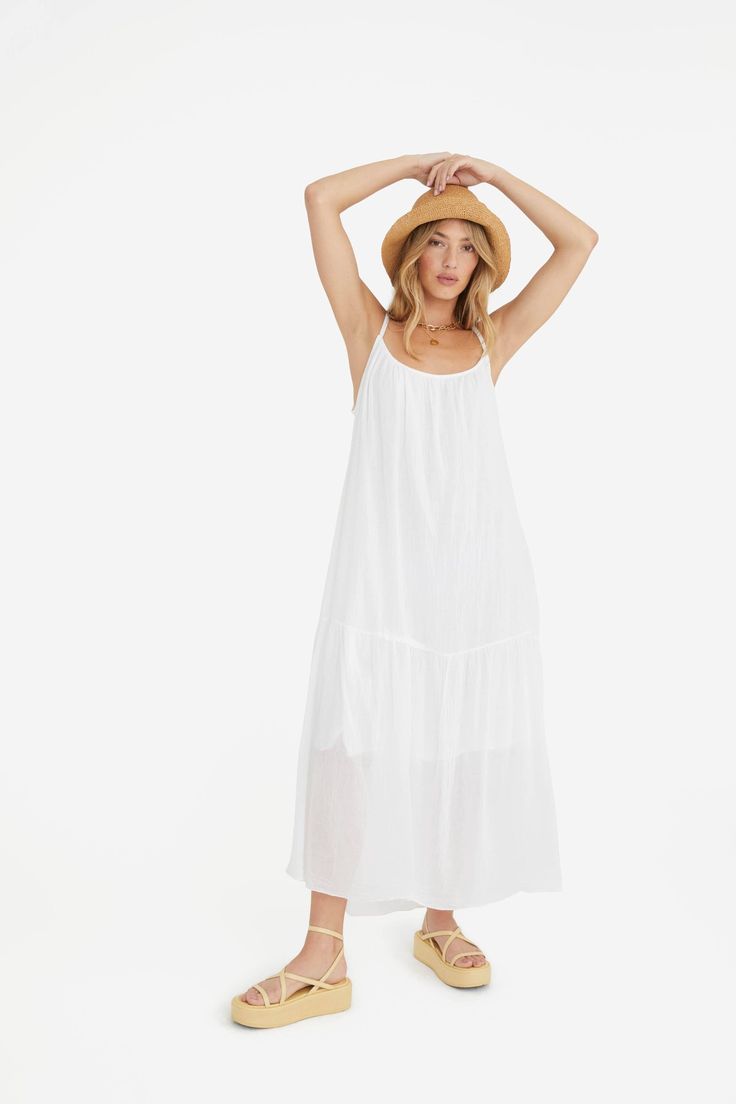 This elegant dress is a timeless staple, made of airy lightweight fabric for a comfortable fit. Its crisp white color exudes effortless style and comfort, making it a versatile choice for any season. A true must-have for any wardrobe, this dress is sure to become a go-to favorite. Linen cotton blend One size fits most (small - large) Care instructions: hand wash and hang to dry. Made in Italy. Flowy Breezy Midi Dress For Daywear, Airy Midi Dress For Beach And Summer, Airy White Maxi Dress For Summer, White Airy Maxi Dress For Summer, Airy Flowy Midi Dress For The Beach, Airy Maxi Dress For Vacation, White Airy Sleeveless Dress, Airy Sleeveless White Dress, White Breezy Flowy Sundress