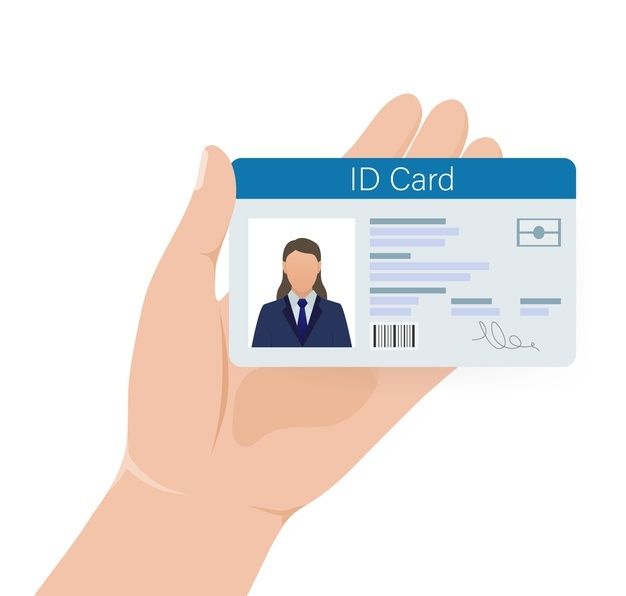 a person holding up a id card in their hand