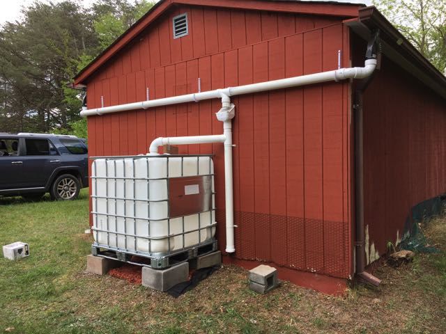 a red building with pipes on the side and a truck parked in front of it