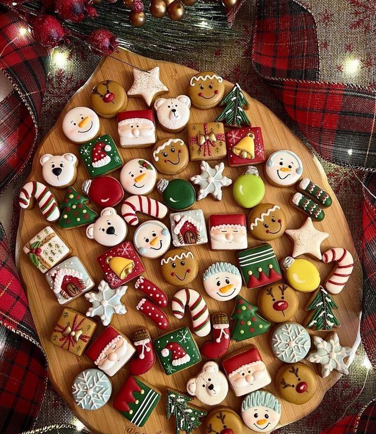 christmas cookies are arranged on a wooden platter