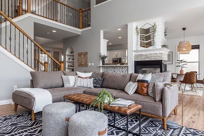 a living room filled with furniture and a fire place in the middle of a room