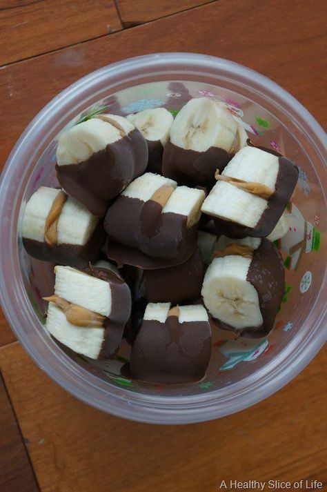 a plastic bowl filled with chocolate and banana slices