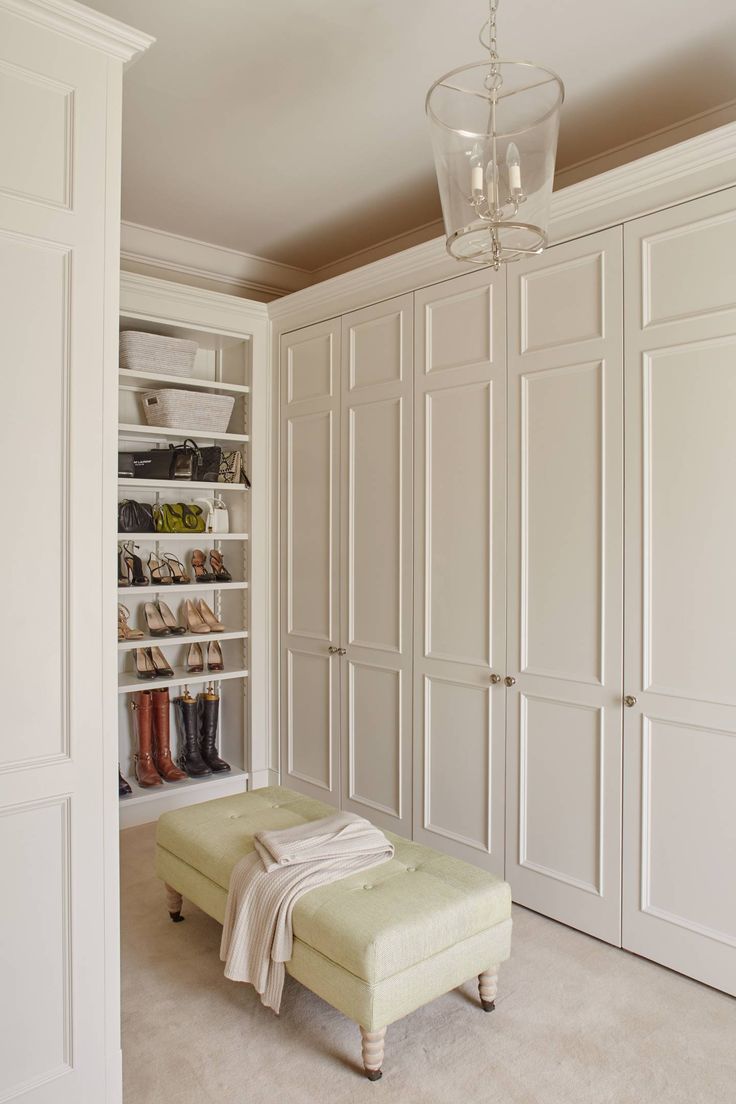 a white closet filled with lots of shoes and blankets on top of it's shelves