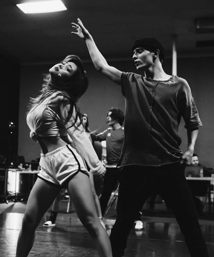 a man and woman dancing in a dance studio