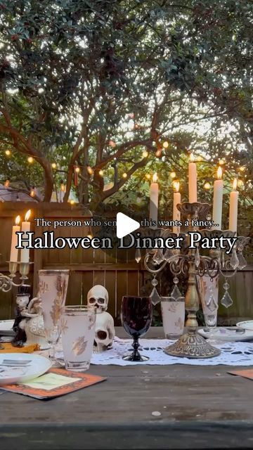 an outdoor dinner party with candles and skulls