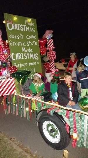 people are riding in the back of a truck decorated with christmas decorations