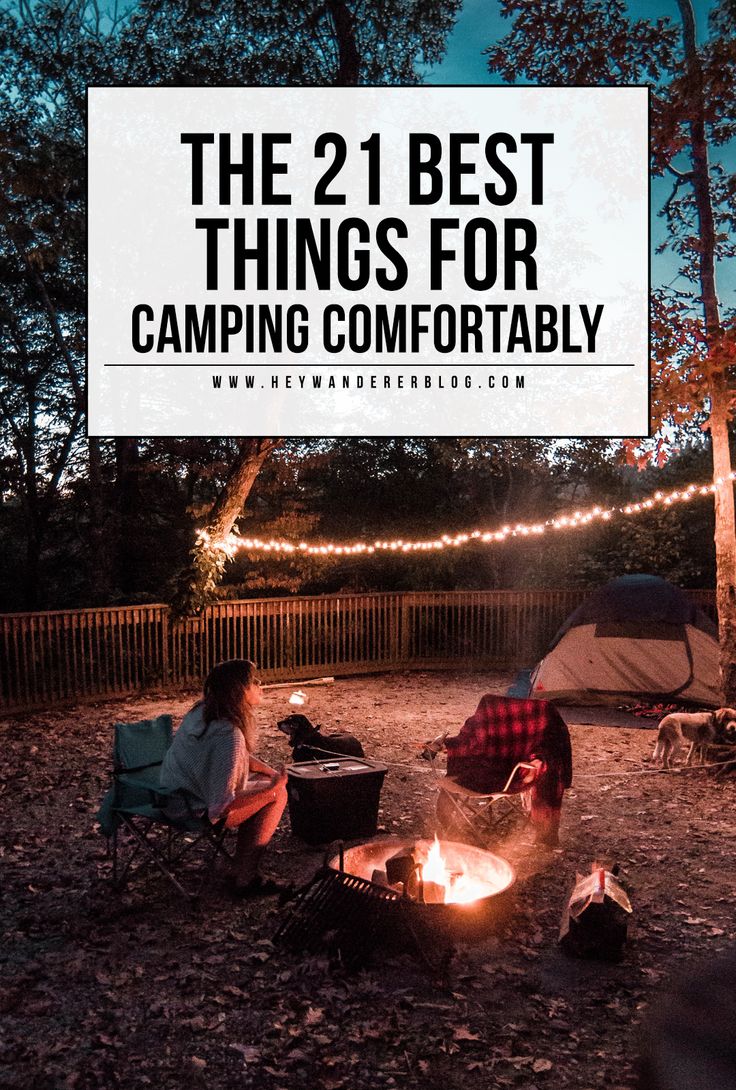 two people sitting around a campfire with the text, the 21 best things for camping comfortably