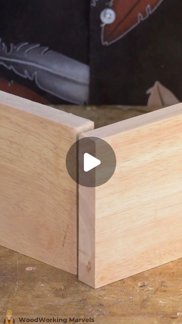 a close up of a wooden box on a table with woodworking materials in the background