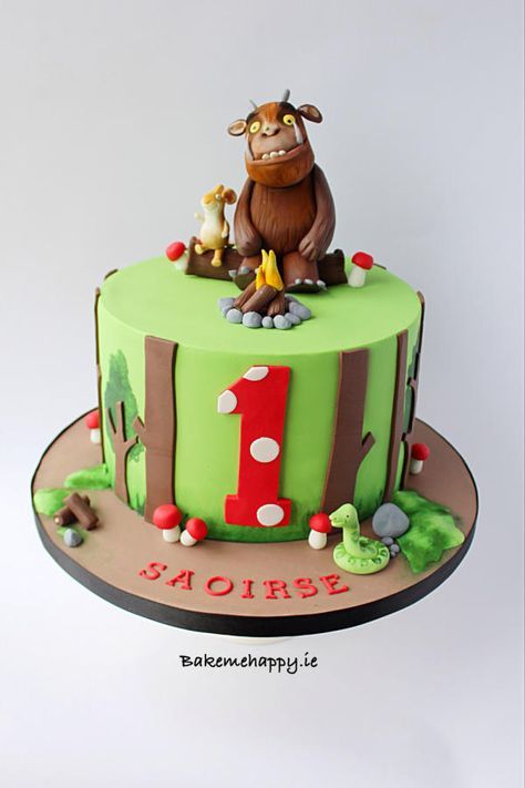 a green birthday cake with an animal on top