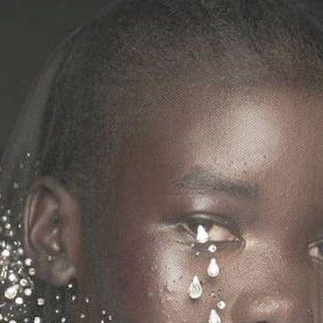 a close up of a person with jewelry on their face