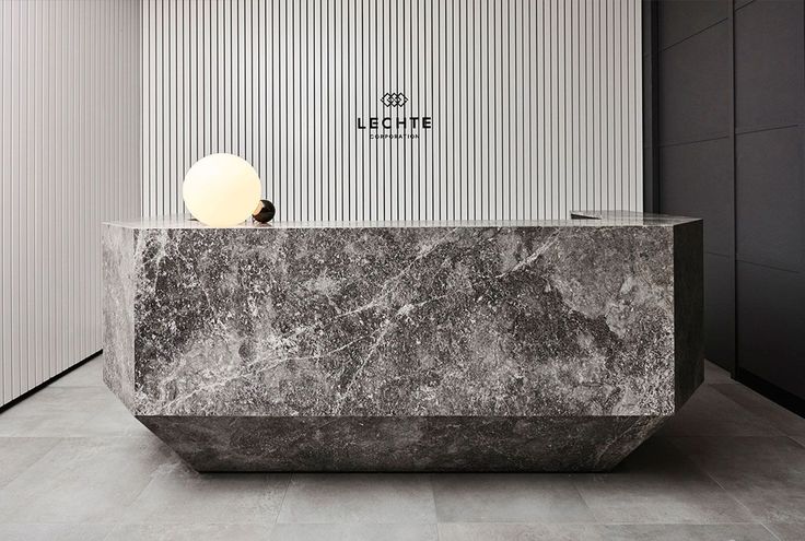 a marble counter top in front of a wall with a white ball on the edge