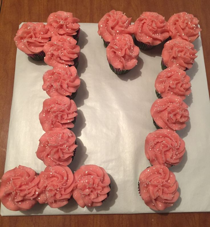 cupcakes with pink frosting are arranged in the shape of the letter e