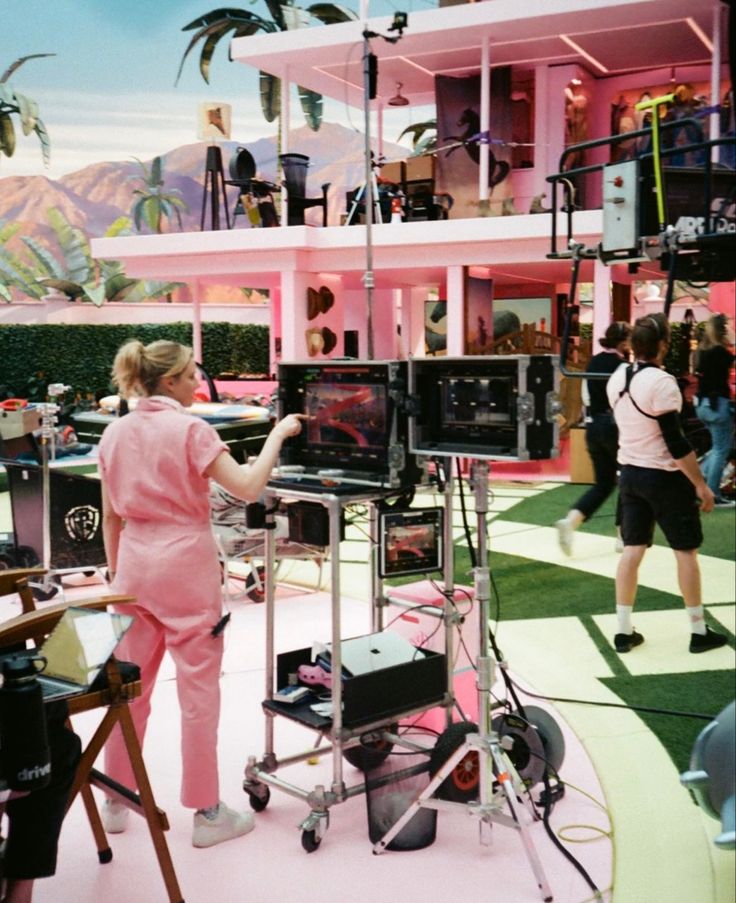 a woman standing in front of a television set