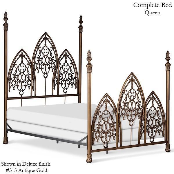 the bed is made up and has intricate ironwork