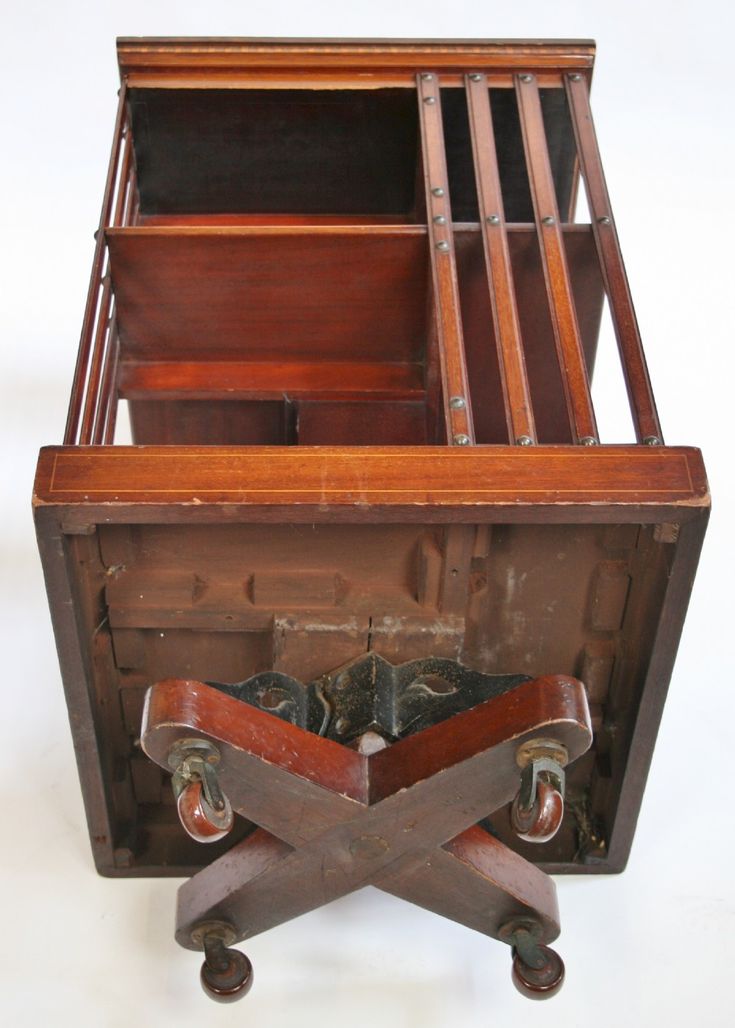 an old wooden desk with drawers and wheels