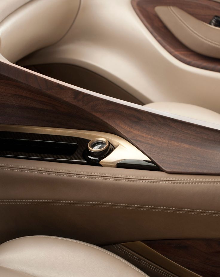 the interior of a luxury car with wood trim