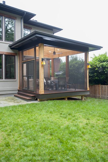 a house with a covered patio in the grass